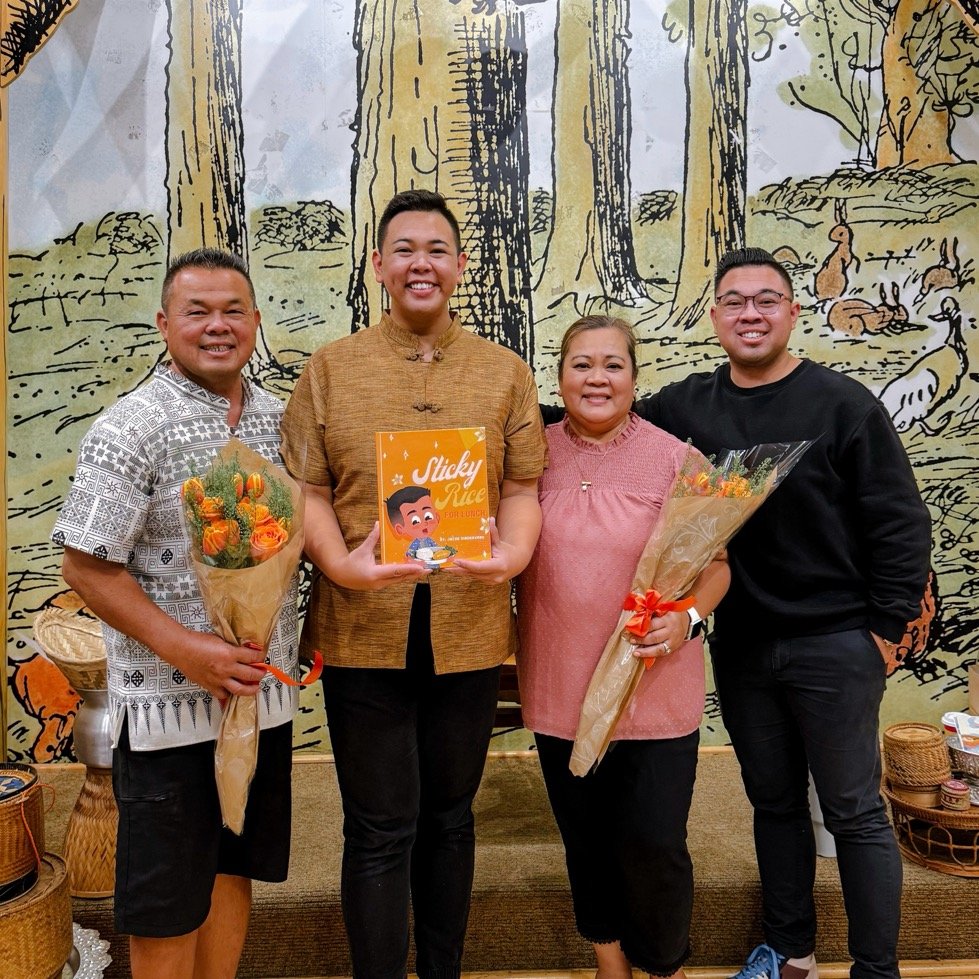Jacob Singhavong holding Sticky Rice for Lunch, with three family members holding flower bouquets