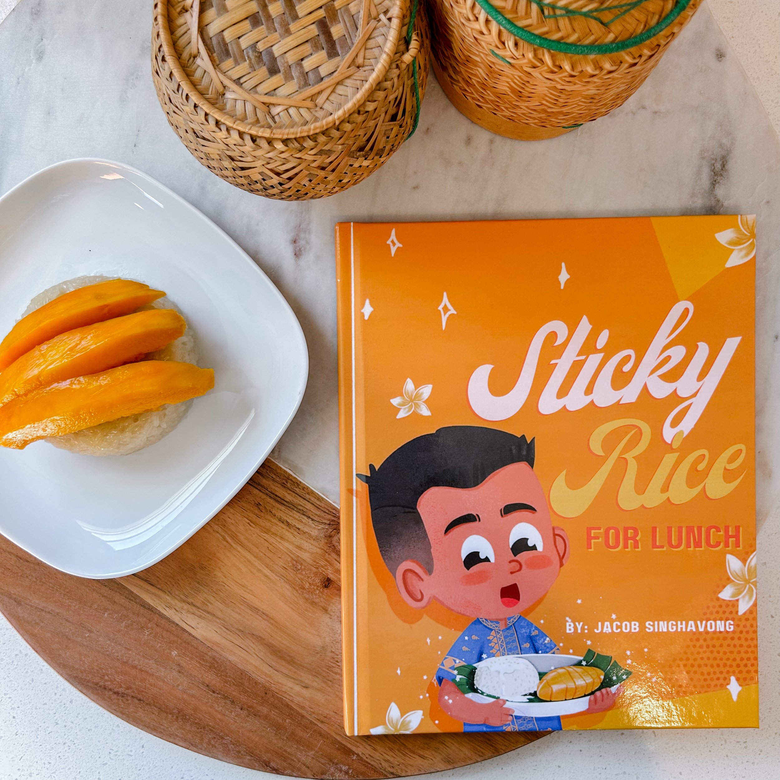 Cover of Sticky Rice for Lunch by Jacob Singhavong, beside mango sticky rice and woven sticky rice baskets