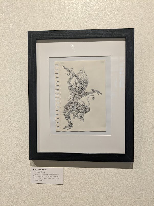 Framed pen drawing of Hanuman leaping with a weapon, by S. Bay Koulabdara, in a gallery