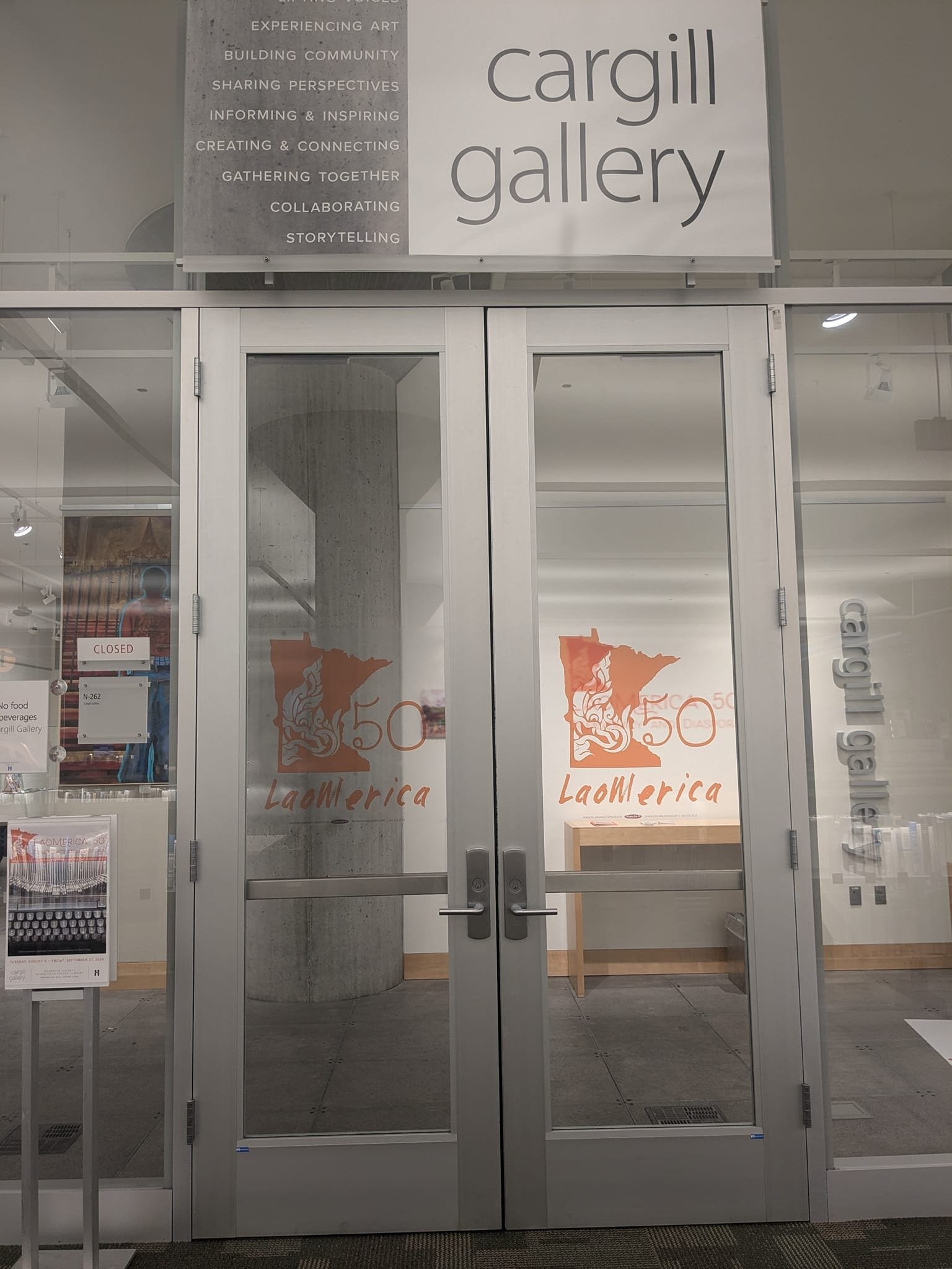 Glass doors of the Cargill Gallery marked with the Laomerica 50 logo