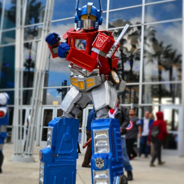Cosplayer in a towering Optimus Prime costume outside the Long Beach Convention Center