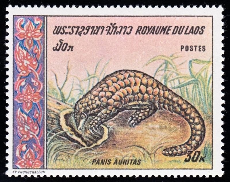 Royaume du Laos postage stamp, 30 kip, showing a pangolin, Panis auritas, digging in grass