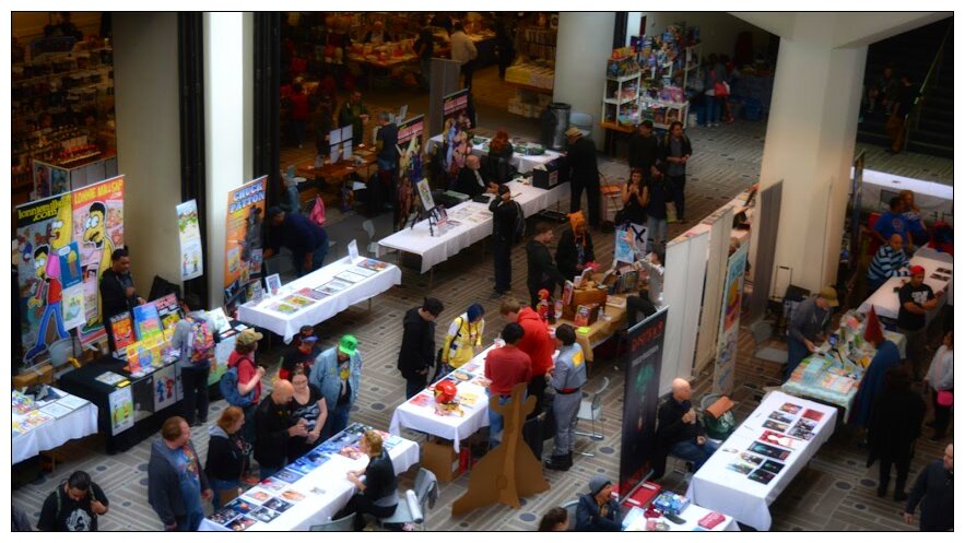 Overhead view of the Pasadena Comic Con exhibit floor with vendor tables and attendees