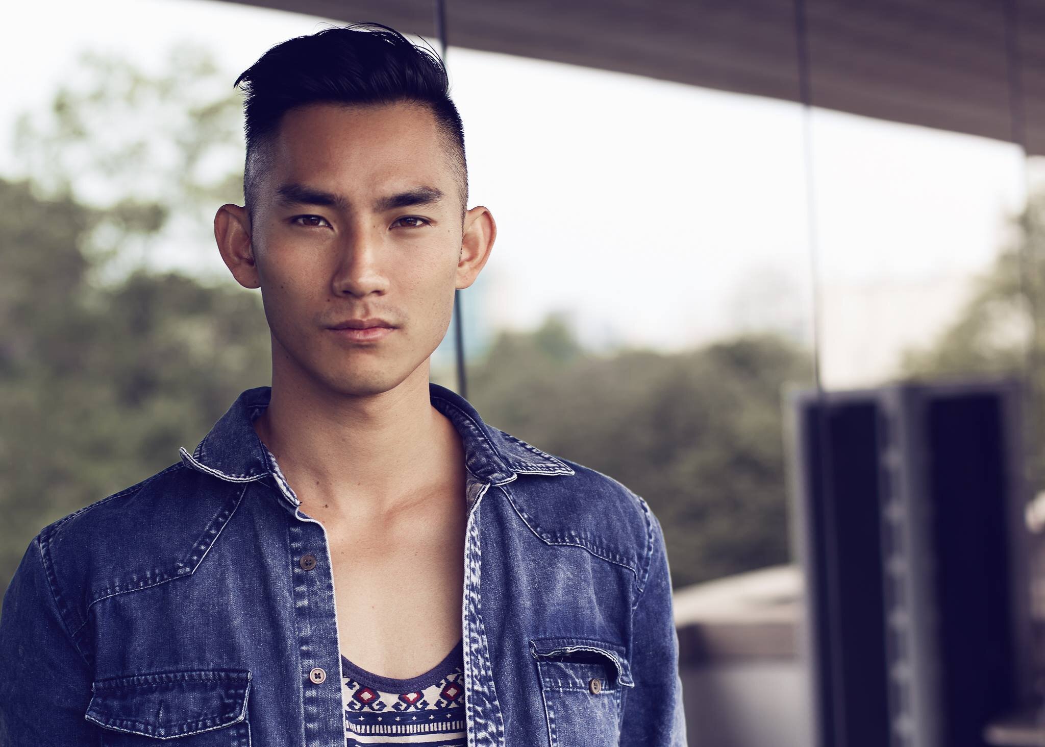 Portrait of Krysada "Binly" Panusith Phounsiri in a denim jacket