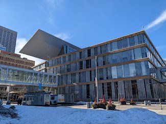 Exterior of the Minneapolis Central Library on a sunny winter day, with snow in front