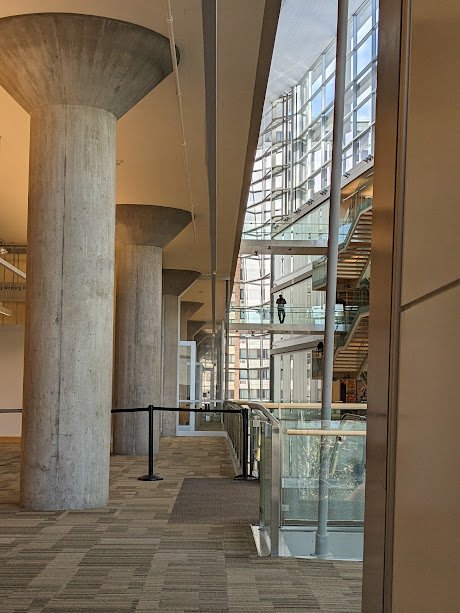 Interior of the Minneapolis Central Library with tall concrete columns and a glass atrium