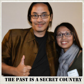 Smiling man giving a thumbs up beside a smiling woman, captioned The Past Is a Secret Country