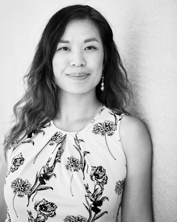 Black and white portrait of artist Sisavanh Phouthavong in a floral sleeveless top
