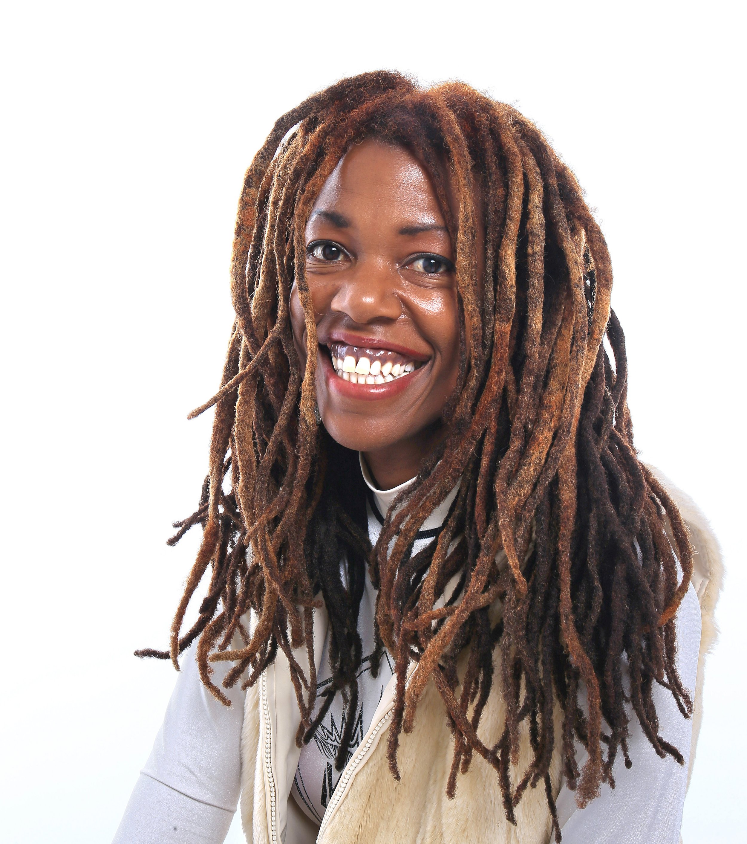 Lisa Teasley smiling, with long locs, against a white background