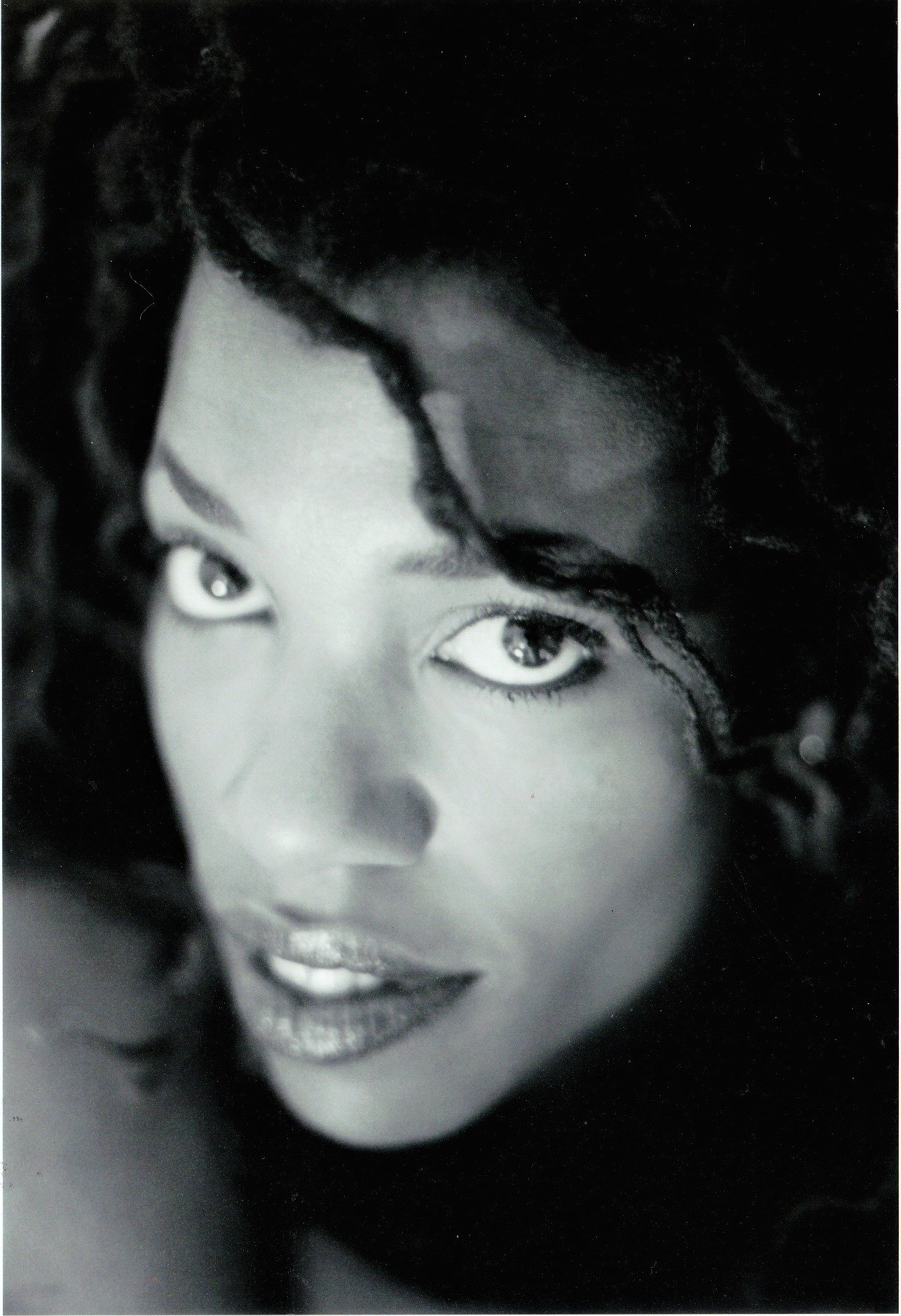 Black and white close-up portrait of Lisa Teasley gazing at the camera