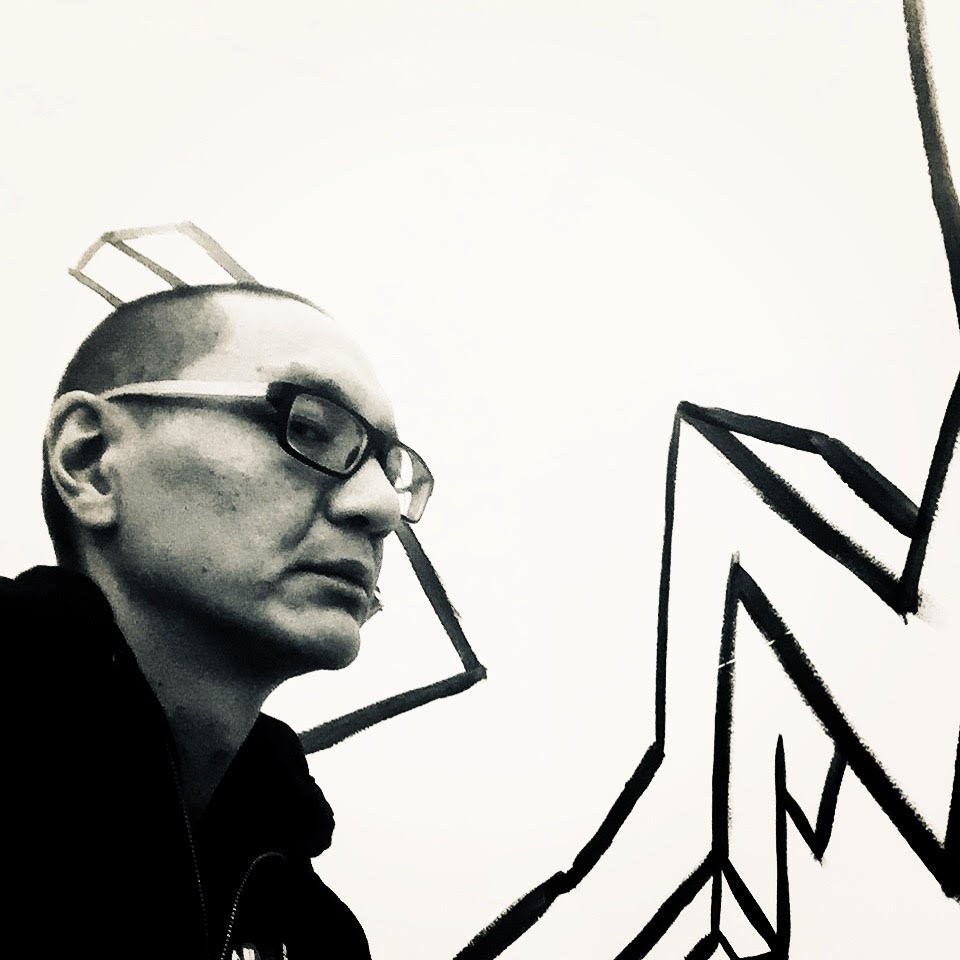Black and white photo of Oura Sananikone in glasses beside bold black line art